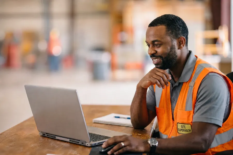 A site supervisor using a laptop